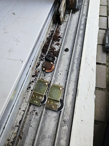 Sliding door rollers being installed in track